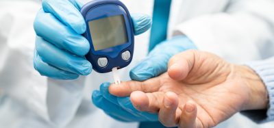 Doctor check diabetes from finger blood sugar level with finger lancet.