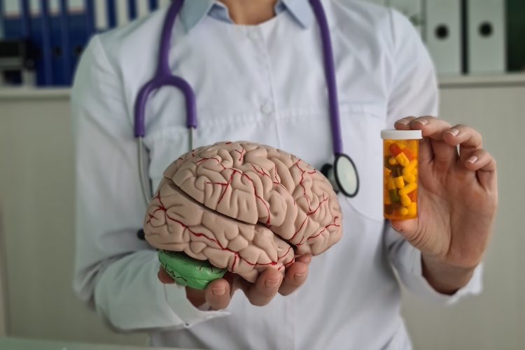 Doctor holds psycho neurological pills for brain in hands