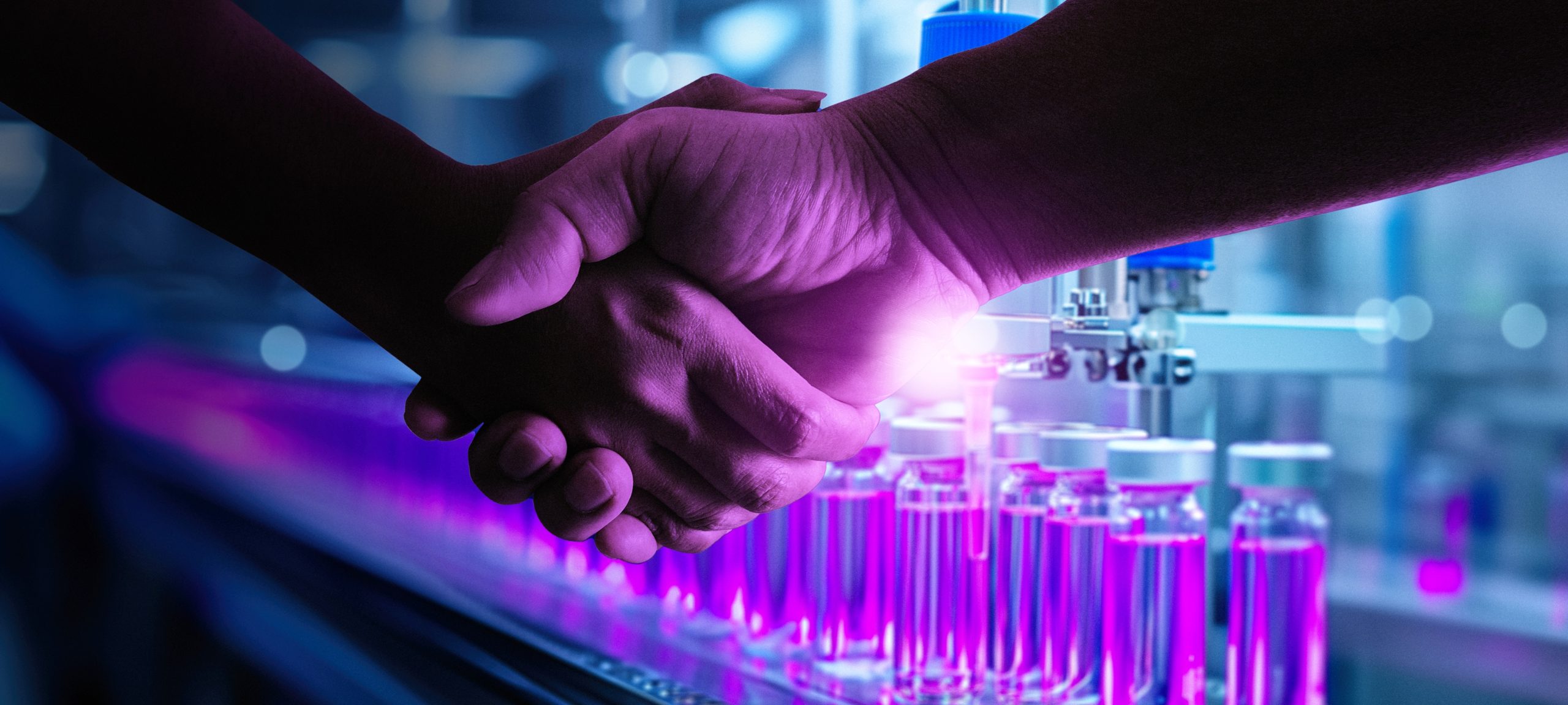 Two scientists shaking hands in a laboratory setting