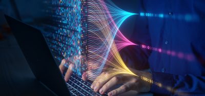 Scientist computing, analysing and visualizing complex data set on computer.