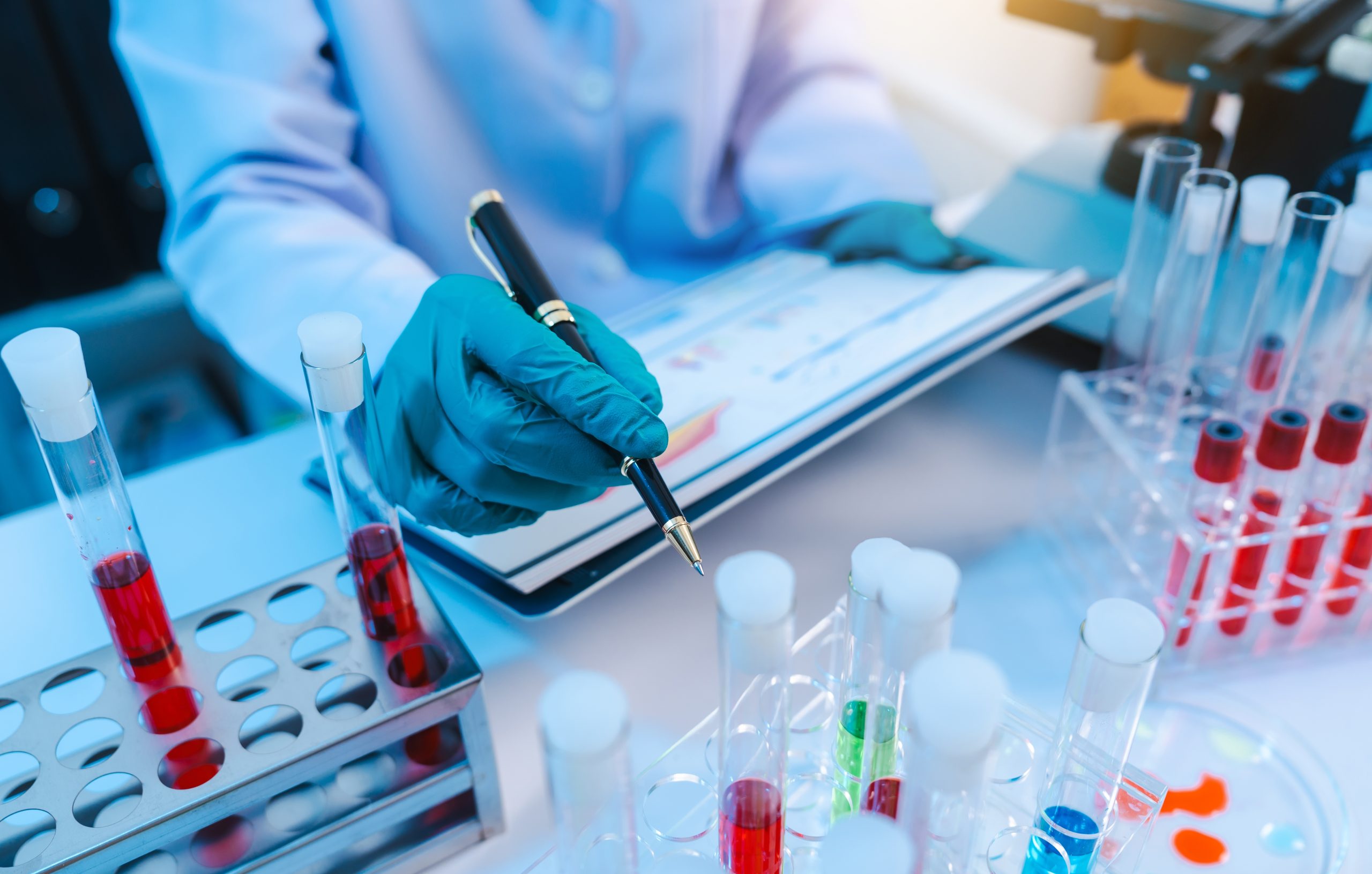 Scientists in lab coat working with test tubes