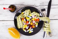 Measuring tape and pills for dieting concept