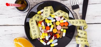 Measuring tape and pills for dieting concept