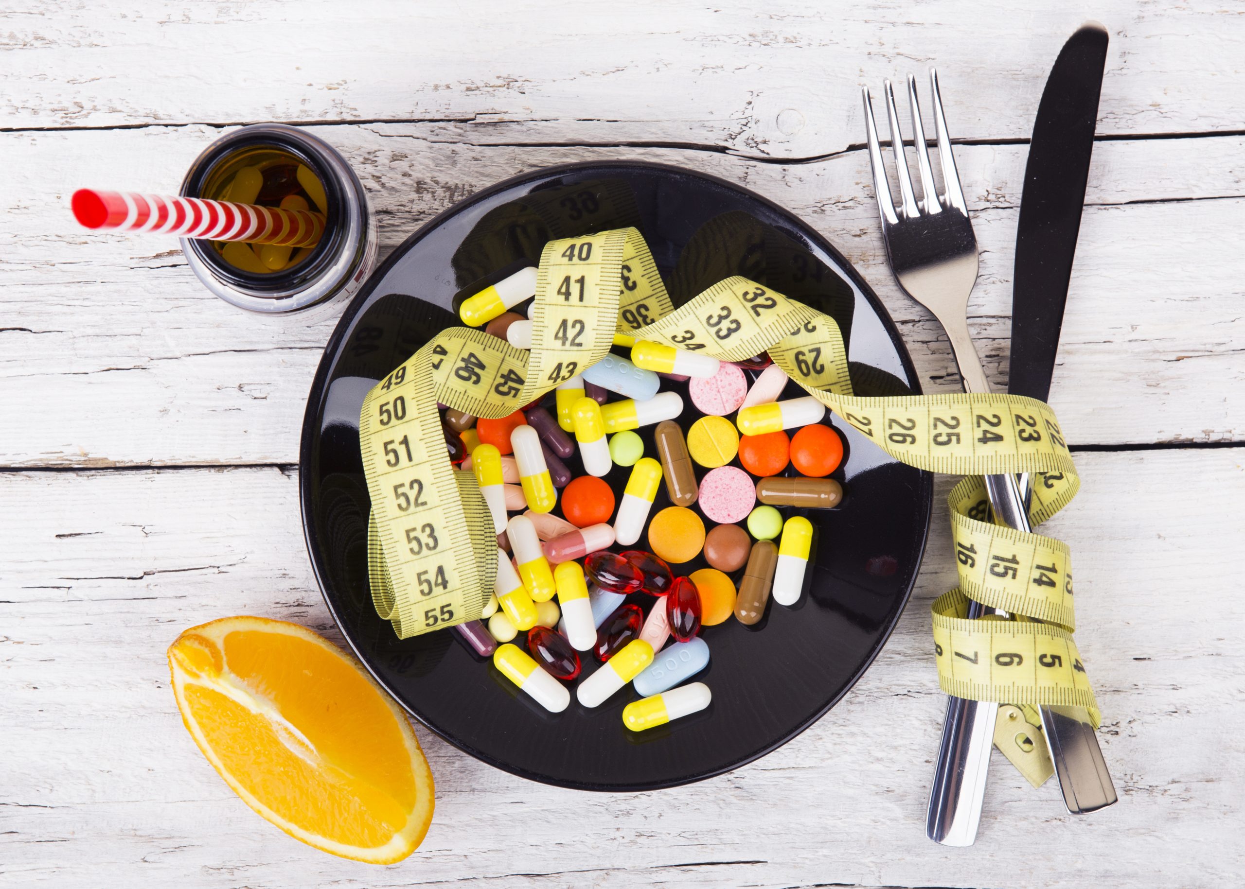 Measuring tape and pills for dieting concept